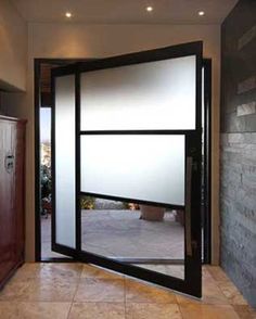 an open door leading into a room with stone walls and tile flooring on both sides