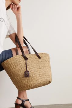 Paris meets Provence in SAINT LAURENT's pastoral 'Panier' tote. It's woven from natural raffia that nods to carefree summer days in the country, while the leather straps lend a touch of urban attitude. It's equally suited for vacation and the office. Fill it with your favorite paperback or tablet. Raffia Tote Bag, Straw Bags, Raffia Bag, Basket Bag, Saint Laurent Bag, Canvas Shoulder Bag, Dark Brown Leather, Leather Handles, Open Top