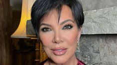 a close up of a person with a necklace and earrings on her neck posing for the camera