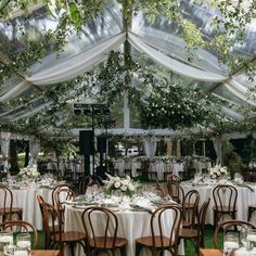 an outdoor tent with tables and chairs set up