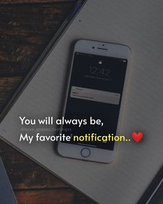 an iphone sitting on top of a desk next to a notepad with the words you will always be, my favorite notification