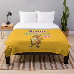 a bed with a yellow blanket that says buddy the slotter on it's side