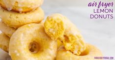 a pile of lemon donuts sitting on top of a white plate with the words air fryer lemon donuts