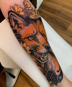 an orange and black fox with flowers on it's arm