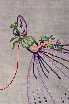 an embroidered piece of cloth with flowers on it