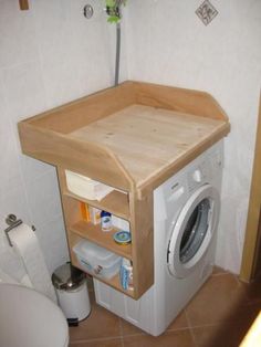 a small washer and dryer in a bathroom