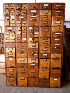 an old wooden filing cabinet filled with lots of drawers