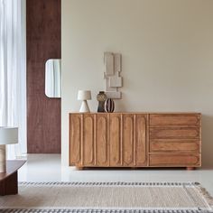 a living room with a large wooden cabinet in the center and two lamps on either side