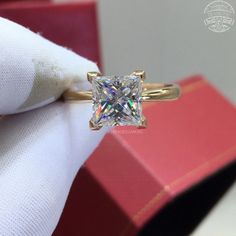 a ring with a princess cut diamond on it