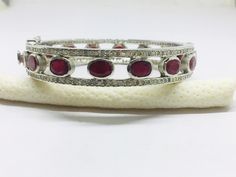 Listing is for (1) one beautiful Solid sterling silver 925 two tone pave diamond ruby bangle (price for one psc.) diamond wt: 2.1 cts. silver wt: 45 gms. stone wt: 8 cts. Gemstone name:- Diamond Ruby It's a beautiful bracelet (bangle). two tone pave diamond ruby bangle perfect for summers. Light weight . perfect for gifting and wedding. We keep on adding new products & designs every day so keep coming back to get more deals & designs. Bulk & wholesale orders are welcome on this desig Diamond Bangle Fine Jewelry Hallmarked, Hallmarked Diamond Bangle Fine Jewelry, Silver Ruby Jewelry With Pave Setting, Oval Bangle With Diamond Accents In Fine Jewelry Style, Silver Bangle With Pave Setting, Silver Bangle With Pave Setting Fine Jewelry, Silver Bangle With Pave Setting In Fine Jewelry Style, Silver Bangle With Pave Setting As Gift, Pave Setting Bangle As Gift