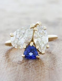 two pear shaped diamond and blue sapphire engagement rings