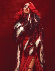 a woman in a red dress and fur coat