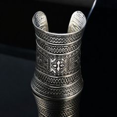 ❖Antique Bracelet, Ethnic Tribal Bracelet, Sliver Bangle, Statemen Cuff, Ceremonial Gift, Wedding Present❖ One Size Fits All What is included?  1x Cuff An silver cuff adorned with intricate embossed patterns, featuring a blend of geometric and floral designs that showcase traditional craftsmanship. High Quality Craftsmanship  Geometric and Floral Design 30 Day Money Back Guarantee My family has dedicated over 8 years to crafting quality products. Every product is made with care and attention to detail. Your support means the world to us as we continue to pursue our passion. ❖Note: Due to the nature of the manufacturing process and image quality, there might be slight variations in color. However, this doesn't affect the quality of the product.❖ Bohemian Cuff Bracelet For Weddings, Bohemian Wedding Cuff Bracelet, Bohemian Silver Metal Cuff Bracelet, Silver Metal Bohemian Cuff Bracelet, Silver Bohemian Metal Cuff Bracelet, Silver Bohemian Cuff Bracelet, Bohemian Antique Silver Metal Bangle, Adjustable Silver Bohemian Bangle, Silver Spiritual Bangle For Festivals