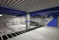 a car is parked in a parking garage with blue and white stripes on the floor