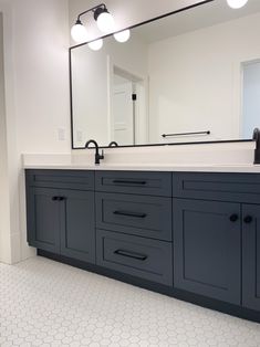 a bathroom with two sinks and a large mirror