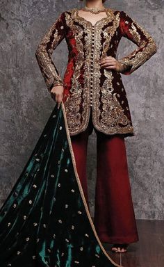 This beautiful short jacket says it all. Elegant maroon velvet jacket with gold tilla aree based, naqshee and zardozi embellishment. Style:Short Jacket Embroidery: Gold tilla aree base, Naqshee & Zardozi embellishments Fabric: Velvet Bottom: CottonSilk Izaar Colour: Maroon Price includes: Jacket, Shawl & Izaar Includes: Jacket Shawl Izaar Velvet Long Sleeve Traditional Wear For Weddings, Festive Lehenga With Gold Embroidery, Long Sleeve Velvet Salwar Kameez With Dabka Work, Velvet Salwar Kameez With Dabka Work And Long Sleeve, Designer Velvet Traditional Wear With Long Sleeves, Velvet Long Sleeve Traditional Designer Wear, Festive Embroidered Velvet Sherwani, Velvet Anarkali Traditional Wear With Long Sleeves, Velvet Traditional Wear With Long Sleeves For Festive Occasions