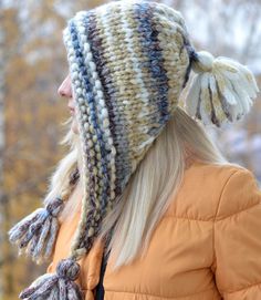 a woman with blonde hair wearing a knitted hat