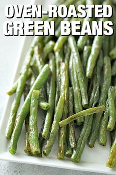 green beans on a white plate with the words oven roasted green beans