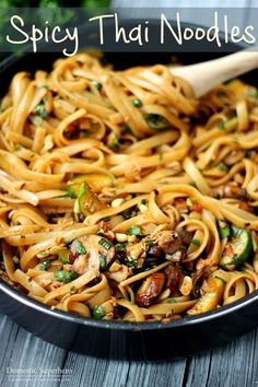 a skillet with noodles and mushrooms in it