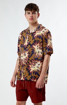 Embrace the essence of summer with our PacSun Printed Camp Shirt. Boasting a collared neckline, short sleeves, and a lightweight feel, it's the epitome of laid-back comfort. Featuring a custom pattern and button closures, this shirt brings a touch of vacation vibes to any outfit.


	Collared neckline
	Short sleeves
	Standard fit
	Button closures
	Lightweight
	Custom pattern
	100% Viscose
	Machine washable
	Model is wearing size medium
	Model Measurements: 6'1” Height, 31” Waist, 33” Inseam Summer Printed Collared Tops, Summer Collared Printed Tops, Summer Polo Collar Top With Graphic Print, Graphic Print Polo Collar Top For Summer, Summer Graphic Print Top With Polo Collar, Yellow Polo Collar Shirt For Summer, Multicolor Polo Collar Top For Summer, Multicolor Floral Print Short Sleeve Shirt For Summer, Summer Multicolor Floral Print Short Sleeve Shirt