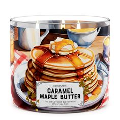 a glass jar filled with pancakes and syrup on top of a tablecloth covered table