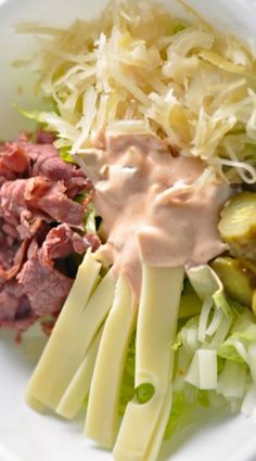 a white bowl filled with salad and dressing