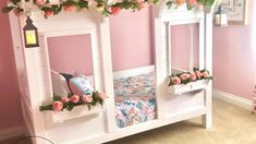 a child's bed with pink flowers on the top and bottom bunk above it