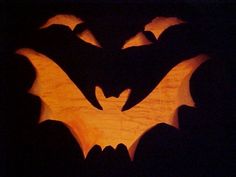 a carved pumpkin with bats on it