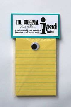 a yellow sticky note pad with the original ipad logo pinned to it's side