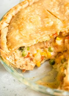 a chicken pot pie is shown with a piece missing from it's pie crust