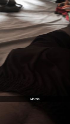 a blurry photo of a bed with black sheets