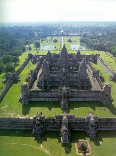 an aerial view of a large building in the middle of a field