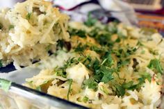 a casserole dish with mashed potatoes and parsley