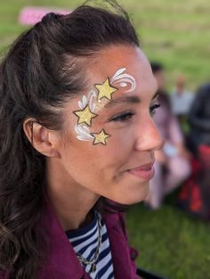 New Year’s Eve Face Paint, Space Themed Face Painting, Stars Face Paint, New Years Face Paint, Uv Face Paint Ideas Simple, Taylor Swift Face Paint, Star Face Paint, Uv Face Paint, Glitter Face Paint