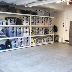 the storage room is filled with lots of plastic bins and boxes on shelving