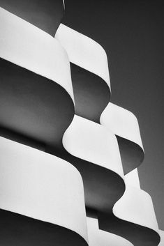 a black and white photo of the side of a building that is shaped like an abstract structure