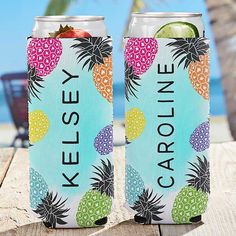 two cans of kelsey pineapple and limeade on a wooden table near the beach