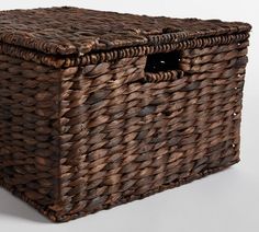 a brown wicker storage basket with handles