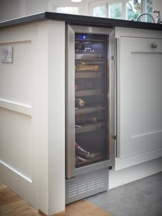 an empty refrigerator in the middle of a kitchen