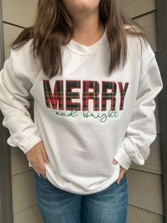 MERRY AND BRIGHT APPLIQUE EMBROIDERED APPAREL♡ Heavy Blend Crewneck Sweatshirt - Unisex♡ Christmas Trees Design♡ 50/50 Cotton/Polyester♡ Made in the U.S.♡ Model is wearing "White"; Size: M; Embroidery Thread: "Red" and "Green" ------------------------------------- CLOTHING SIZE CHARTS WE RECOMMEND SIZING UP FOR A LOOSER FIT. These crewnecks are on the smaller end compared to other brands. We cannot replace a size after receiving your order. ------------------------------------- NOTE: The letters Appliqué Christmas Sweatshirt, White T-shirt With Embroidered Text For Winter, White Winter Top With Embroidered Text, White Embroidered Text Top For Winter, White Embroidered Top For Winter, White Christmas Tops With Embroidered Graphics, Christmas Cotton Top With Embroidered Text, Holiday Embroidered Cotton Top, Christmas Embroidered Sweatshirt