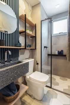 a bathroom with a toilet, sink, and shower stall is shown in this image