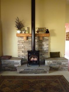 a living room with a fire place in the center and a rug on the floor