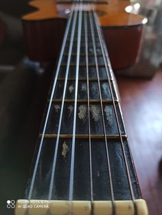 an electric guitar is sitting on the table with its strings still attached to it's neck