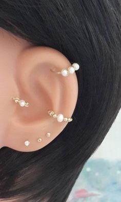 a close up of a fake ear with pearls on it