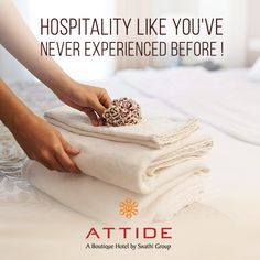 a woman is stacking towels on top of a bed with the words, hospitality like you've never experienced before