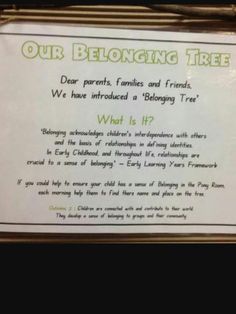 a sign hanging on the side of a building that says, our belonging tree dear parents, families and friends we have introduced a belong tree