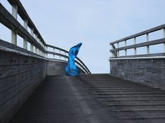 a blue sculpture sitting on top of a set of stairs