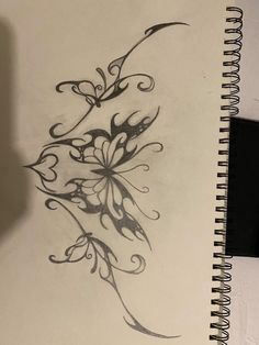 a drawing of a flower is shown on a notebook