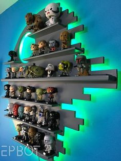 star wars action figures are displayed on shelves in a room with blue walls and green lighting