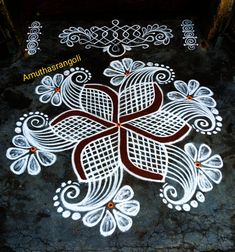 an intricate design on the ground in white and brown